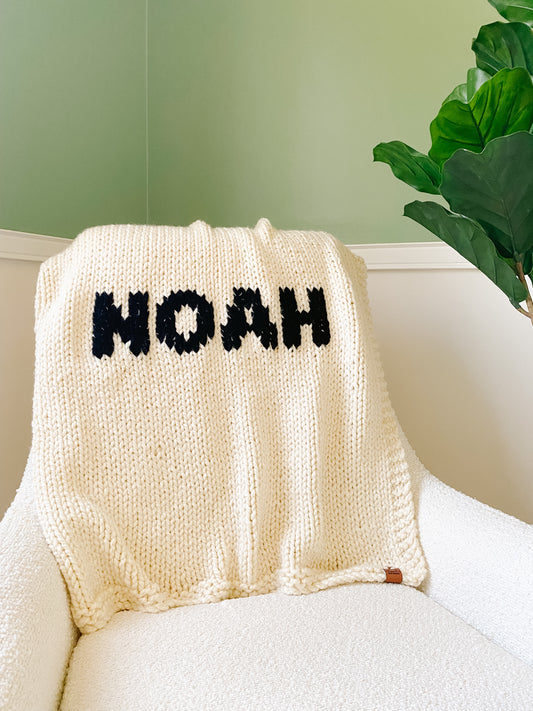 Cream blanket with Black lettering